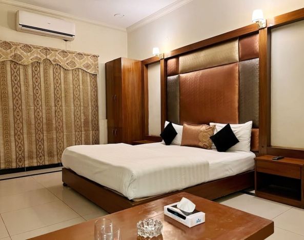 King bedroom with air conditioning at The Grand Hotel Multan.