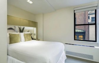 Guest room at The Shoreham, with double bed and large window.