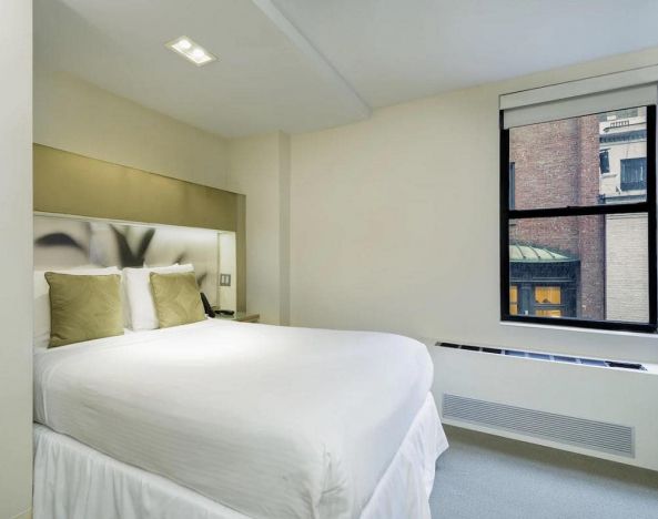 Guest room at The Shoreham, with double bed and large window.
