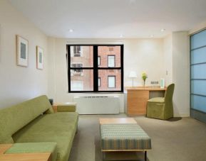 Lounge in one of The Shoreham’s guest rooms, including table, desk, chair, and sofa.