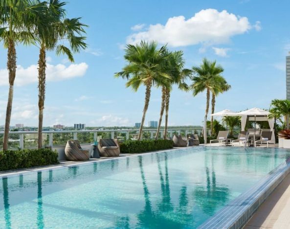 Relaxing pool area with sun chairs at The Altair Hotel Bay Harbor.