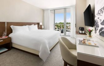 Spacious king bedroom with work desk at The Altair Hotel Bay Harbor.