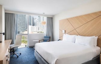 Spacious delux king bed with work desk at Novotel Miami Brickell.