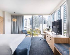 Spacious king bed with TV and work station at Novotel Miami Brickell.