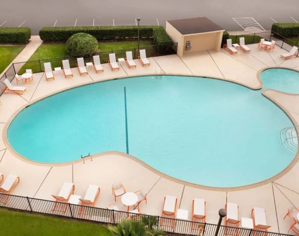 Stunning outdoor pool with sun beds at Holiday Inn Houston Intercontinental Airport.