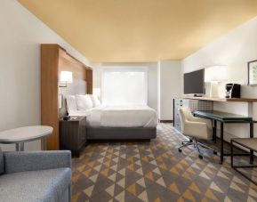 Spacious delux king with lounge, TV, and work station at Holiday Inn Houston Intercontinental Airport.