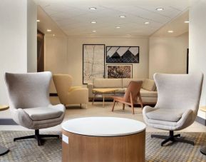 Comfortable lounge and coworking space at Holiday Inn Houston Intercontinental Airport.