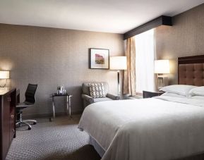 Comfortable king bed with business desk and TV at Wyndham Phoenix Airport/Tempe.