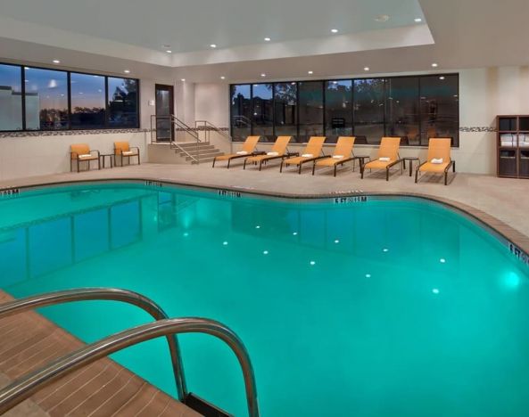 Lovely indoor pool with chairs at Courtyard Philadelphia City Avenue.