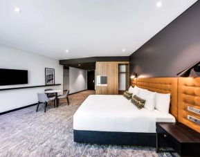 Spacious delux king room with TV at Vibe Hotel North Sydney.