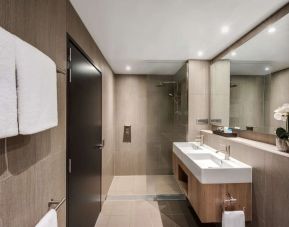 Private guest bathroom with shower at Vibe Hotel North Sydney.