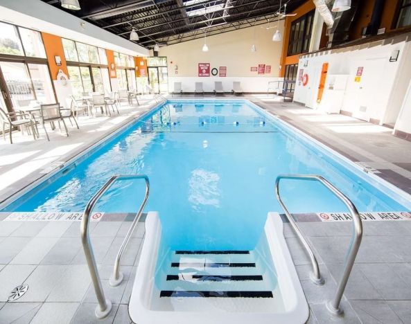 Lovely indoor pool with seating area at Best Western Plus Ottawa/Kanata Hotel & Conf.