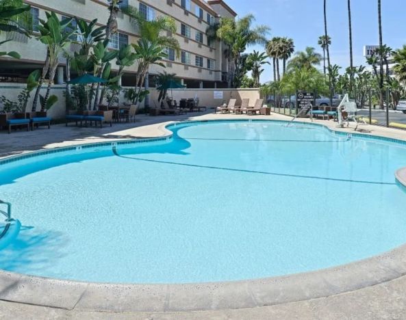 Stunning outdoor pool with pool chairs at Best Western San Diego Zoo/SeaWorld Inn & Suites.