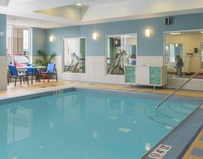 Large indoor pool with seating area at Holiday Inn Express North Bay.