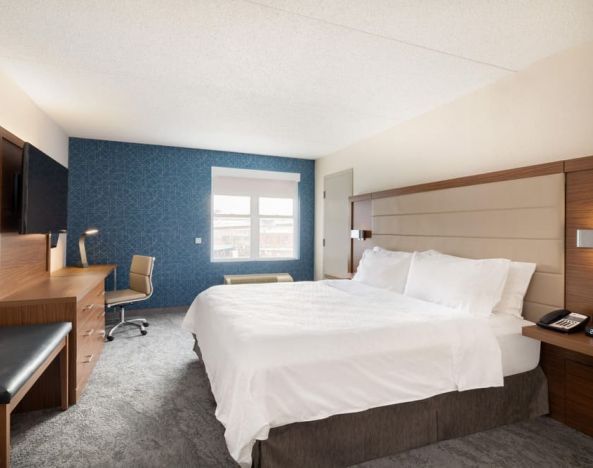 Delux king room with desk and TV at Holiday Inn Express & Suites Boston-Cambridge.