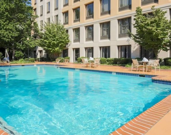 Stunning outdoor pool with seating area at DoubleTree Atlanta Airport.