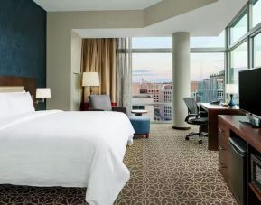 King bed with TV and natural light at Hilton Garden Inn Washington DC / Georgetown Area.