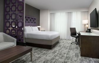 King bedroom with TV and business desk at Courtyard San Diego Downtown.