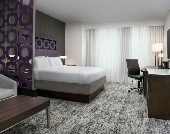 King bedroom with TV and business desk at Courtyard San Diego Downtown.