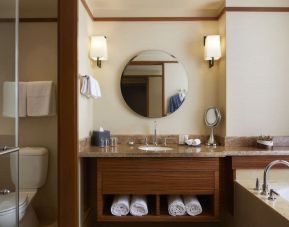 Guest bathroom with bath and shower at Pan Pacific Seattle.
