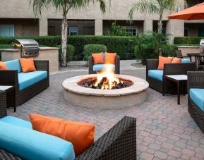 Outdoor lounge and coworking space with fire pit at Hyatt House Scottsdale.