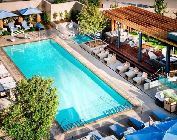 Lovely outdoor pool with pool chairs at Hotel Nia, Autograph Collection.