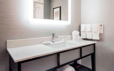 Guest bathroom with shower at Courtyard By Marriott Boston Brookline.