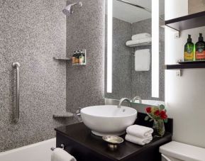 Private guest bathroom with shower and bath at Capitol Hill Hotel.