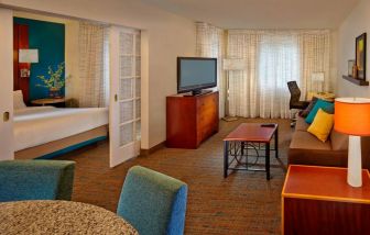 Day use room with TV and lounge area at Residence Inn Boston Tewksbury.
