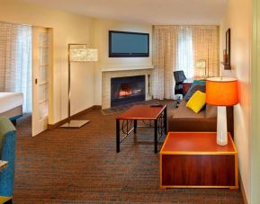 Spacious king room with TV and lounge at Residence Inn Boston Tewksbury.
