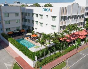 Pool area surrounded by pool chairs and greenery at Circa 39 Hotel.