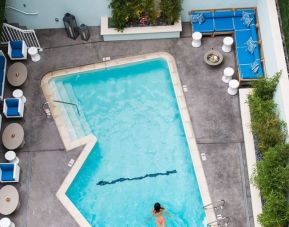Refreshing outdoor pool surrounded by sun loungers at Maison 140 Beverly Hills.