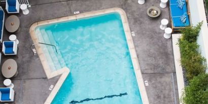 Refreshing outdoor pool surrounded by sun loungers at Maison 140 Beverly Hills.