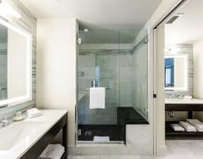 Private guest bathroom with shower at The Mosaic Hotel Beverly Hills.