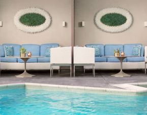 Relaxing pool area with comfortable seating at The Mosaic Hotel Beverly Hills.