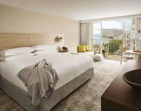 Delux king room with natural light and work space at Alohilani Resort Waikiki Beach.