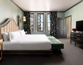 King bed with TV at The Candler Hotel Atlanta, Curio Collection By Hilton.