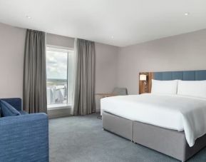Delux king bed with natural light at Hilton Garden Inn London Heathrow Terminals 2 And 3.