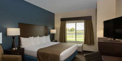 Day use room with work desk and sofa at AmericInn By Wyndham Sioux Falls North.