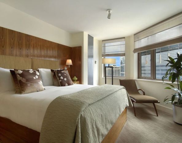 King bed with natural light at Fairmont Chicago at Millennium Park.