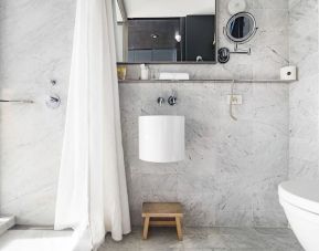 Private guest bathroom with shower at Selina Chelsea New York City.