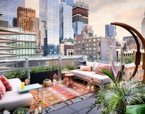 Stunning rooftop terrace with city views at Selina Chelsea New York City.