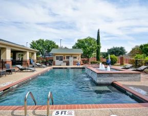 Stunning outdoor pool at Homewood Suites By Hilton Dallas-Lewisville.