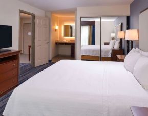 Delux king bed with TV at Homewood Suites By Hilton Dallas-Lewisville.