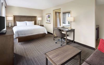 Day use room with work desk and sofa at Hampton Inn & Suites Alexandria.