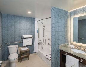 Guest bathroom with shower and bath at Homewood Suites By Hilton Miami Airport-Blue Lagoon.