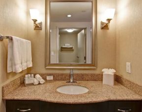 Guest bathroom with shower at Homewood Suites By Hilton Burlington.