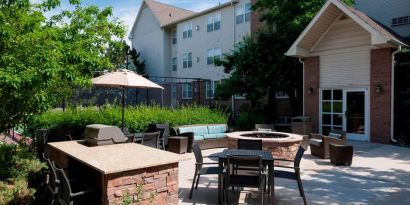 Fire pit and BBQ grill area at Residence Inn By Marriott Denver Highlands Ranch.