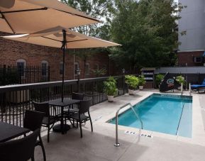 Outdoor pool with seating area at Hampton Inn & Suites Gainesville-Downtown.