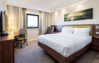 King bed with natural light at Hampton By Hilton Humberside Airport.